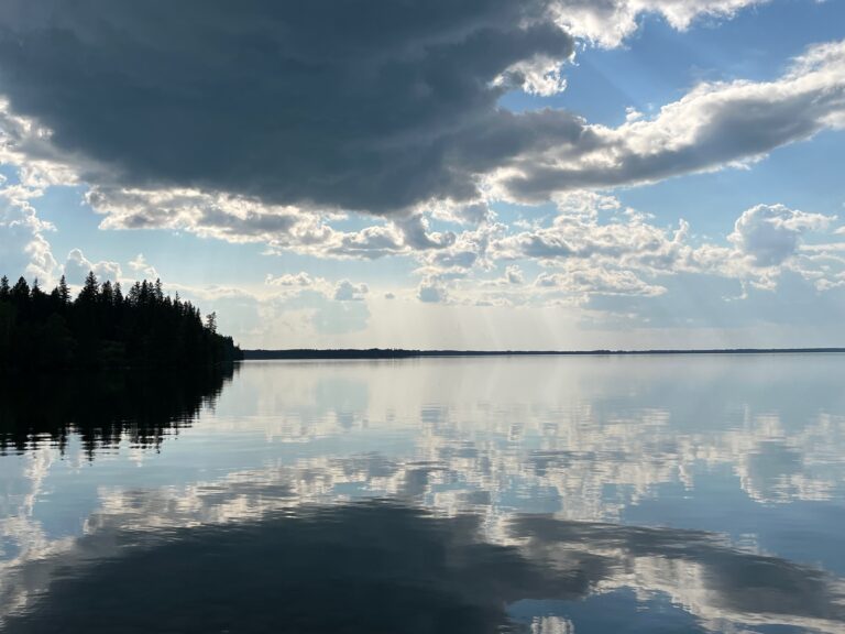 Reflection of clouds over the water in Riding Mountain National Park